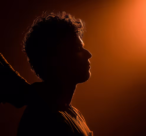 A silhouette of a man holding a tennis racket.