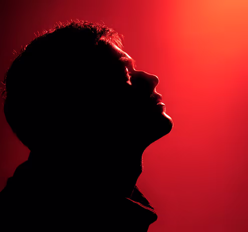 A silhouette of a man with his mouth open.