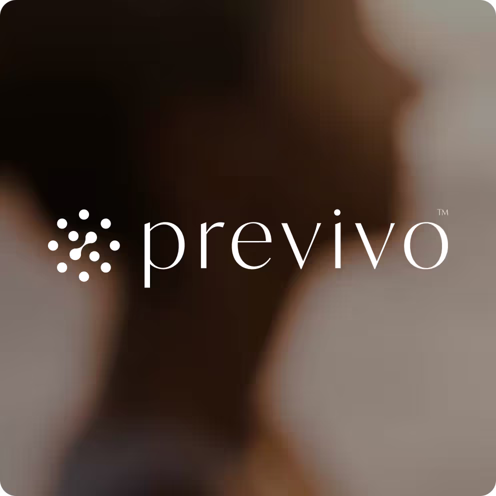 A blurry photo of a woman's face with the word previno.