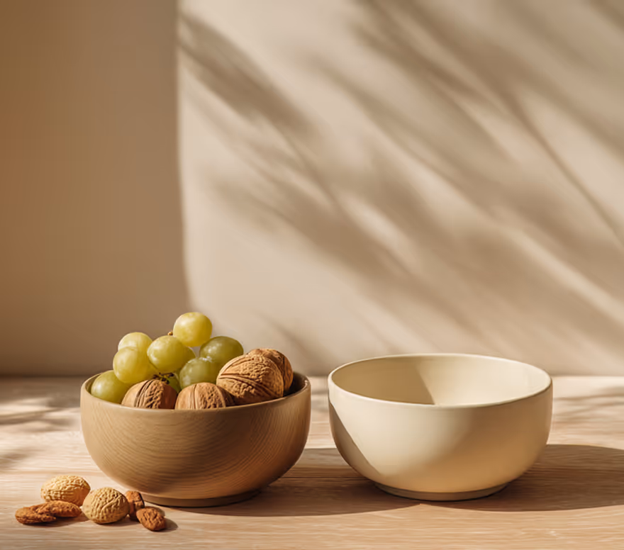 Bowls of grapes, nuts, and other foods on a table