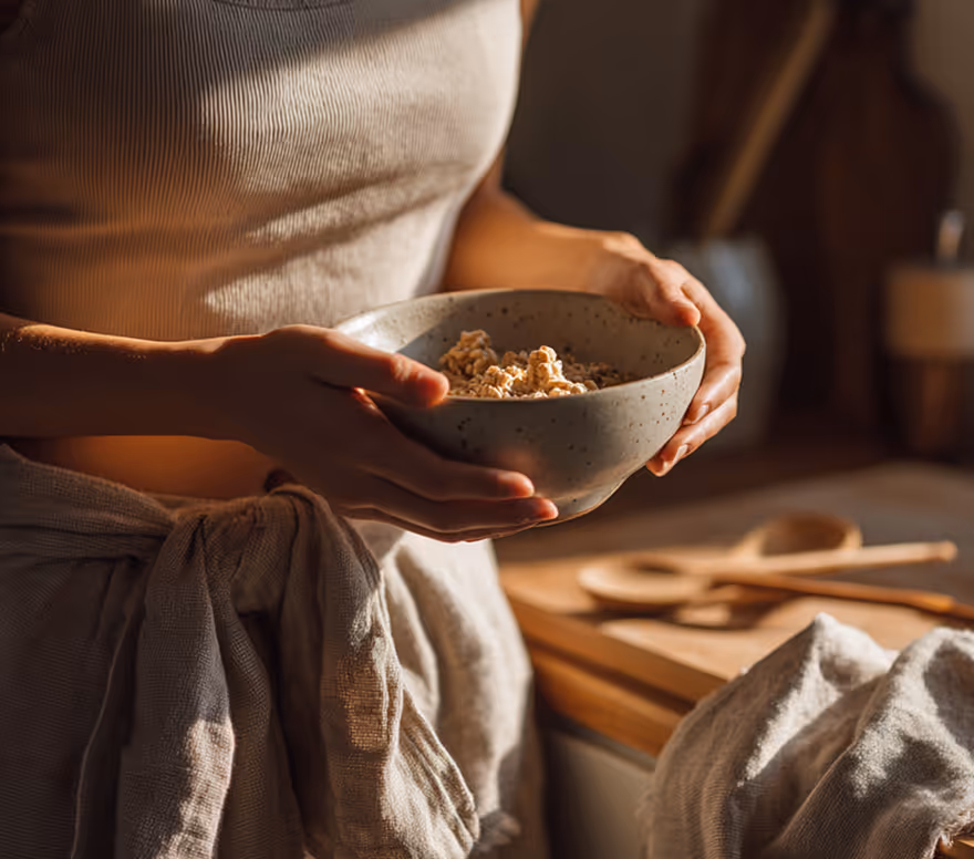 Hands preparing a bowl of food