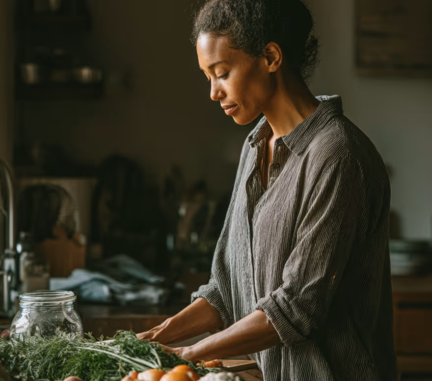 Woman preparing leafy greens in a kitchen