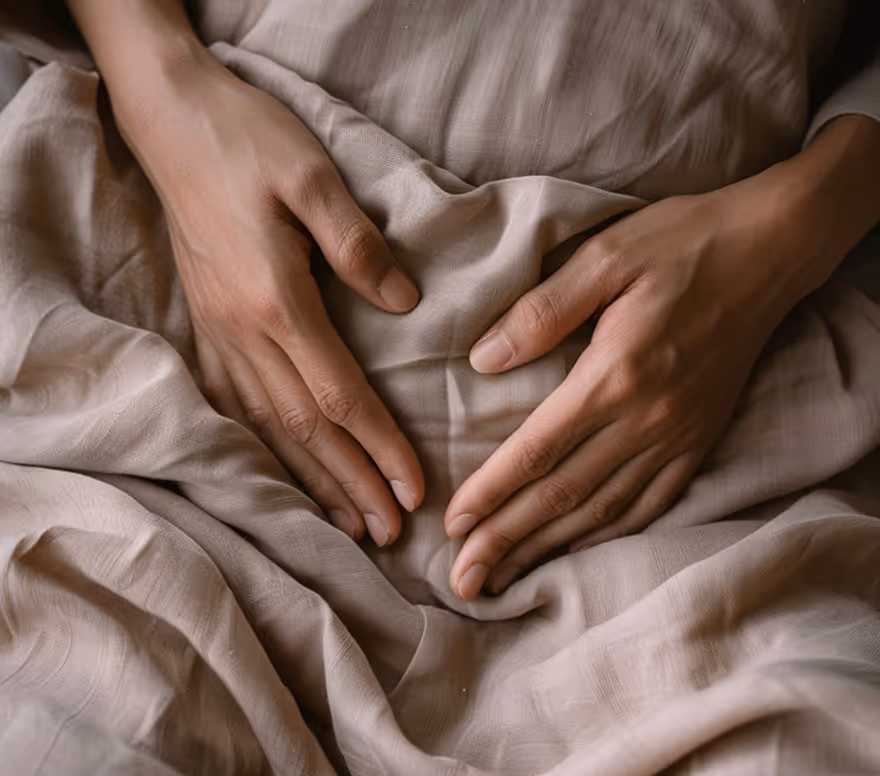 Hands resting over the abdomen