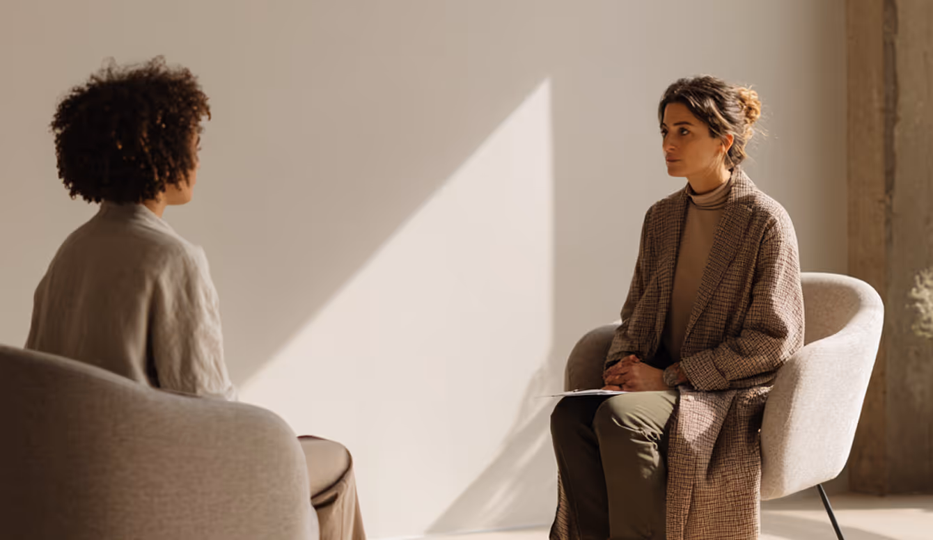 Two men seated for a clinic consultation