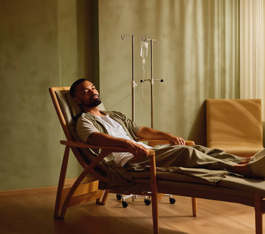 Man reclining beside an IV stand