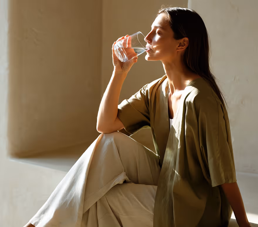 Woman drinking water while seated