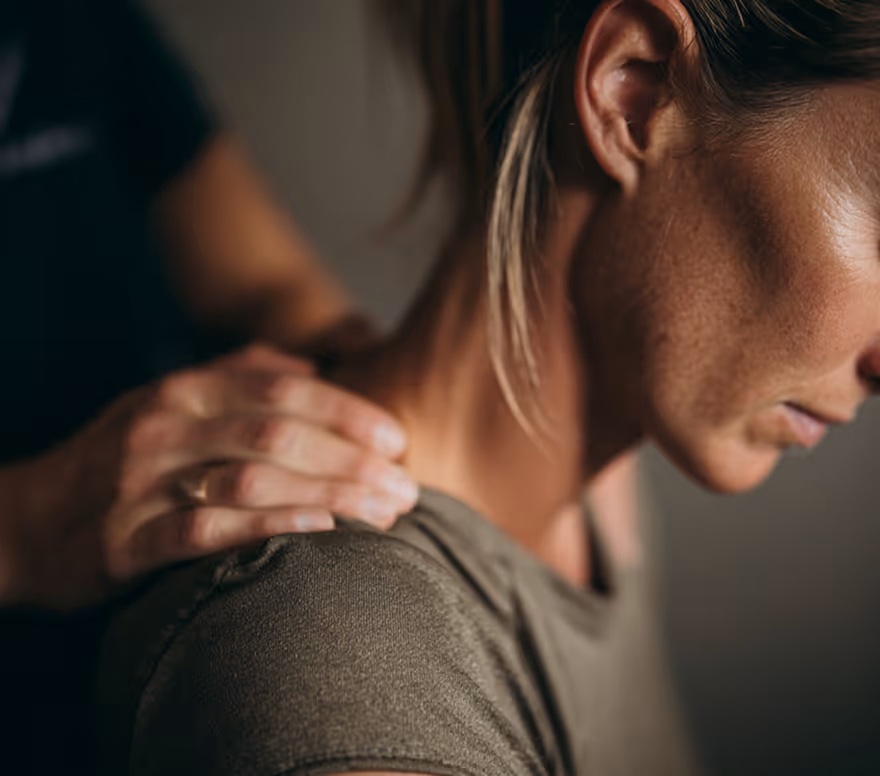 Practitioner massaging a client's shoulder