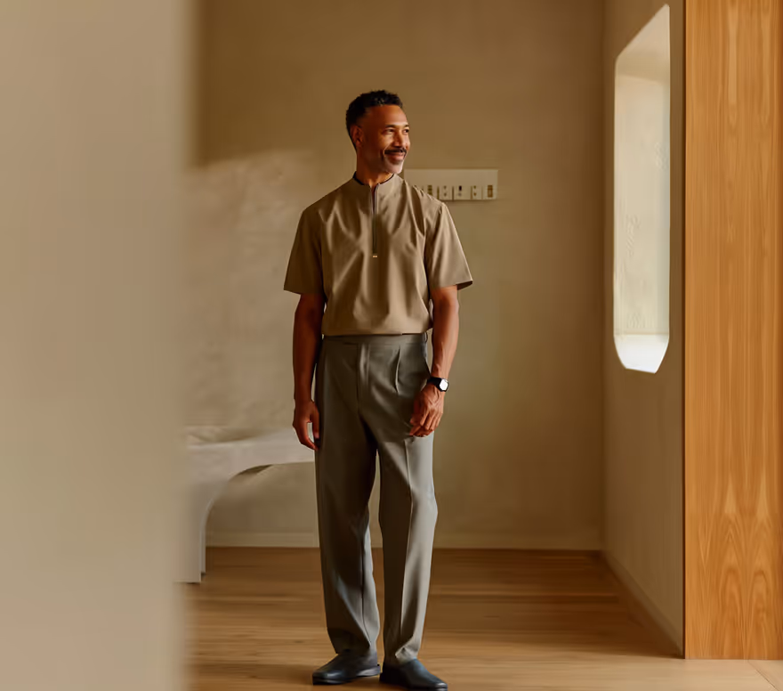 Man standing in a sunlit clinic corridor